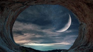Cave opening onto a view of an exoplanet's moon